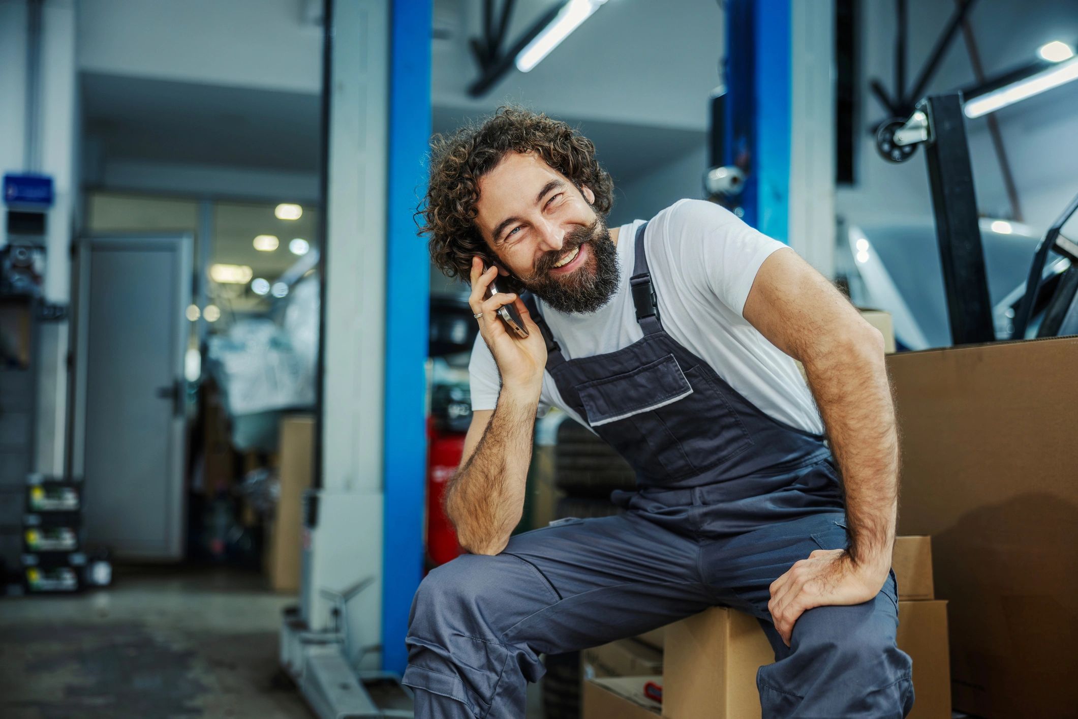 Mechanic talking on the phone in a workshop